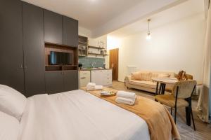 a bedroom with a bed and a living room at PHOS Nest in Serres +27 photos