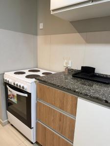 una cocina con estufa y encimera en Edif Alarif Piso 7F, en Posadas