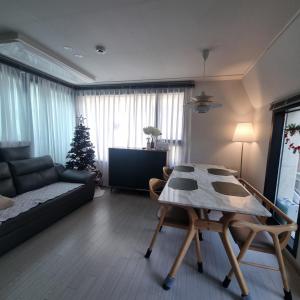 a living room with a table and a christmas tree at YYStay 감성 루프탑 in Seoul