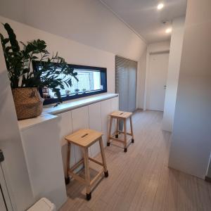 a living room with two stools and a window at YYStay 감성 루프탑 in Seoul