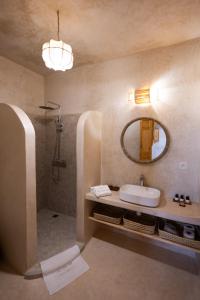 a bathroom with a sink and a mirror at Riad le myrath in Essaouira