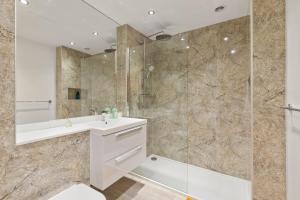 a bathroom with a sink and a shower at Khayat Homes - The Ford in Chelmsford