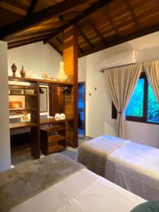 a bedroom with two beds and a sink in it at Tua Pousada Boutique Tatuamunha, Rota Ecológica dos Milagres, Porto de Pedras, Alagoas in Tatuamunha +166 photos