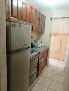 una cocina con refrigerador y estufa en Departamento Morrocoy Ixtapa, en Ixtapa 7 fotos más