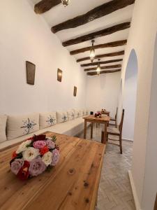 a room with a table with flowers on it at Riad le myrath in Essaouira +59 photos