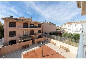 a balcony of a building with benches on it at Apartamentos de Miguel in Vinebre