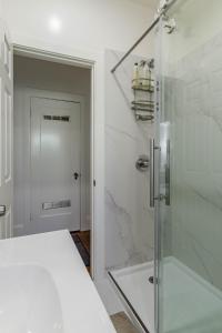 a bathroom with a shower with a glass door at 1 Berkeley - Entire Apartment - Private, Spacious in Berkeley +16 photos