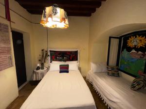 Postel nebo postele na pokoji v ubytování Atelier Oaxaca