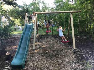 a boy and a girl playing on a playground at Old Hospital & Sauna at the Beach in Pargas