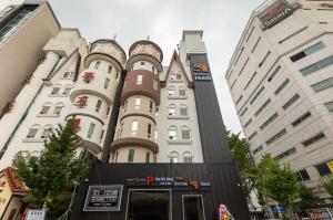 a tall building in the middle of two buildings at 부띠끄 이틀호텔 in Cheongju