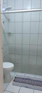 a bathroom with a shower with a toilet and a rug at Casa de Benê in Tramandaí +15 photos