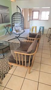 a room with couches sitting on a tiled floor at Richmond Hill Guesthouse- Serviced Condo in Gqeberha +25 photos