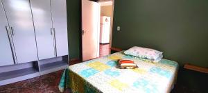 a bedroom with a bed with a quilt on it at Casa de Benê in Tramandaí