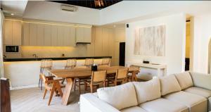 a living room with a table and a couch at Villa Nata Umalas in Seminyak
