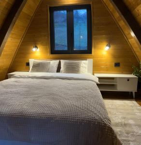 a large bed in a room with a window at Terra Ruj in Mokra Gora