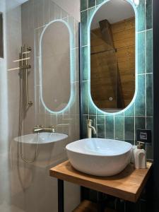 a bathroom with a white sink and two mirrors at Terra Ruj in Mokra Gora +24 photos