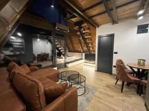 a living room with a couch and a table at Terra Ruj in Mokra Gora