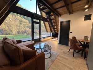 a living room with a couch and a table at Terra Ruj in Mokra Gora