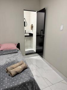 a bedroom with a bed and a large mirror at Suítes da Orla Hospedagens in Arraial do Cabo