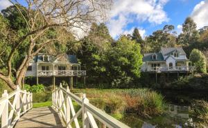 una casa su un ponte sopra un fiume con una casa di Plum Retreat a Apollo Bay