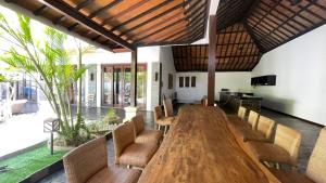 a dining room with a wooden table and chairs at The Trawangan Resort in Gili Trawangan