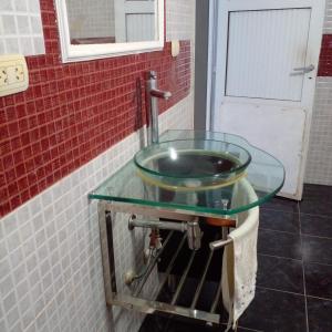 a glass sink in a bathroom with a door at Aires Verdes in General Pico +9 photos