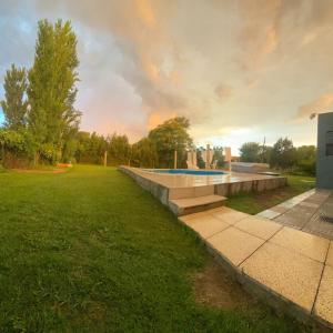 a swimming pool in the middle of a grass field at Aires Verdes in General Pico