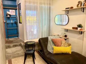 a living room with a couch and a window at Bang Chak Studio in Bangkok