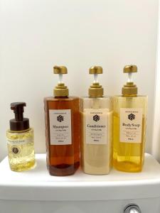 four bottles of essential oils sitting on a shelf at Ogaki Hiyori Hotel - Vacation STAY 70082v in Ogaki