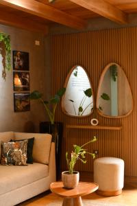 a living room with a couch and two mirrors at Phuyu Hotel in Mendoza