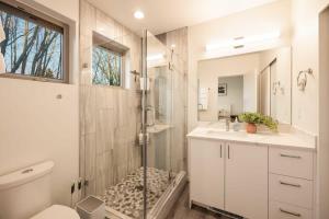 a bathroom with a shower and a toilet and a sink at Brand New 3B2B Designer Home near SeaTac in Seattle