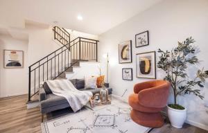 a living room with a staircase and a chair at Brand New 3B2B Designer Home near SeaTac in Seattle