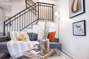 a living room with a couch and a glass table at Brand New 3B2B Designer Home near SeaTac in Seattle +26 photos