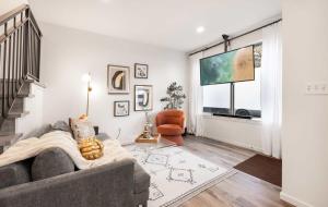 a living room with a couch and a large window at Brand New 3B2B Designer Home near SeaTac in Seattle