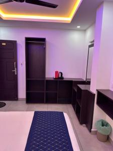 a dressing room with purple walls and a black door at G Mount inn in Munnar