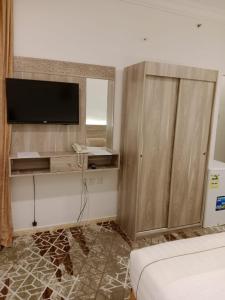 a hotel room with a television and a bed at فندق اوتاد البدر الششه in Al Khansāk +33 photos