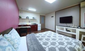 a hotel room with a bed and a television at Yangji Resortel in Hwaseong
