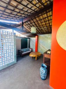 a living room with a couch and a table at Sol da pipa - suítes in Pipa