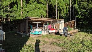a small shack with a boat in it at Red Gate Lodge in Kijimadaira