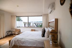 a bedroom with a bed and a large window at Equinoccio Hotel in Santa Ana +74 photos