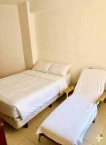 Postel nebo postele na pokoji v ubytování Arena, Mar y Amaneceres para Siete frente a Farmatodo tucacas