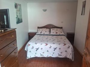 a bedroom with a bed with a bedspread with butterflies on it at San Lorenzo in Caldera