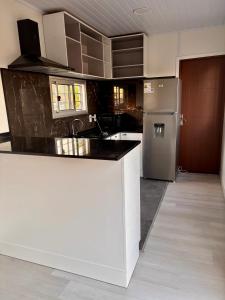 a kitchen with a counter and a refrigerator at Tres de Mayo in San Luis