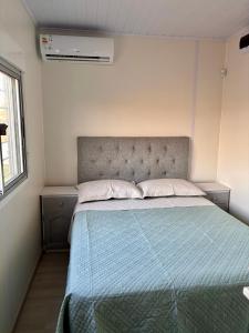 a bedroom with a bed with a blue comforter at Tres de Mayo in San Luis