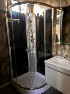 a bathroom with a shower and a sink at Tres de Mayo in San Luis +4 photos
