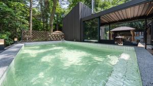 a swimming pool in the backyard of a house at gwangju chez pompom dokchae poolvilla in Gwangju