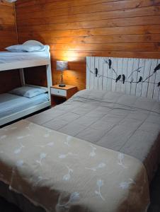 a bedroom with two bunk beds and a lamp at Casa Quinta in Mercedes