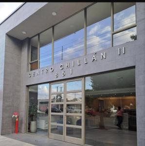 a building with a sign on the front of it at Depto Cómodo y Equipado en el Centro de Chillan con Estacionamiento in Chillán