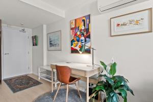an office with a desk and a chair and a plant at Stylish 1-Bed Unit with Secure Parking in Braddon