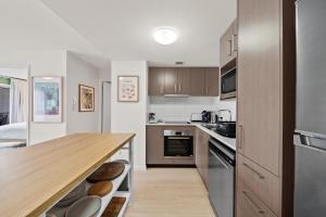 a kitchen with a wooden counter top and a wooden table at Stylish 1-Bed Unit with Secure Parking in Braddon